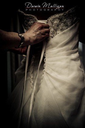 tying the wedding gown