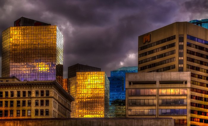 Dramatic light on buildings in downtown Edmonton showing an approaching summer storm