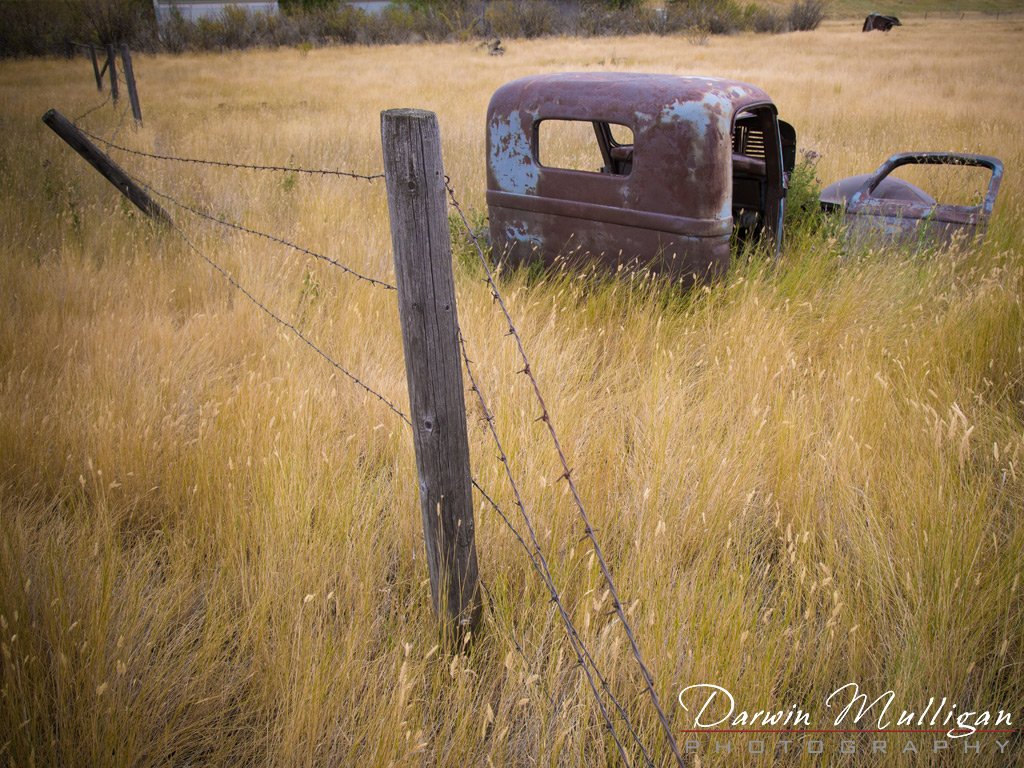 Abandoned-truck-and-fence-in-field-Kevin-Montana