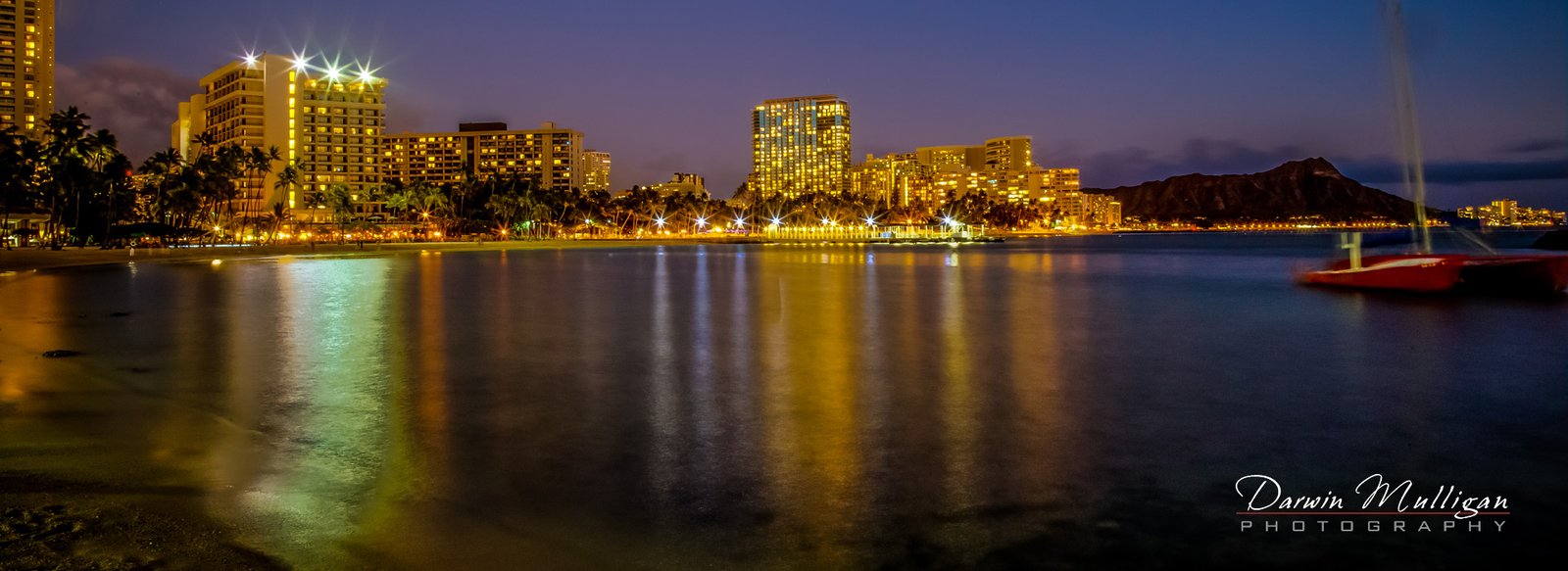 Waikiki-Beach-Honolulu-Hawaii-at-night-with-Diamond-Head-in-background