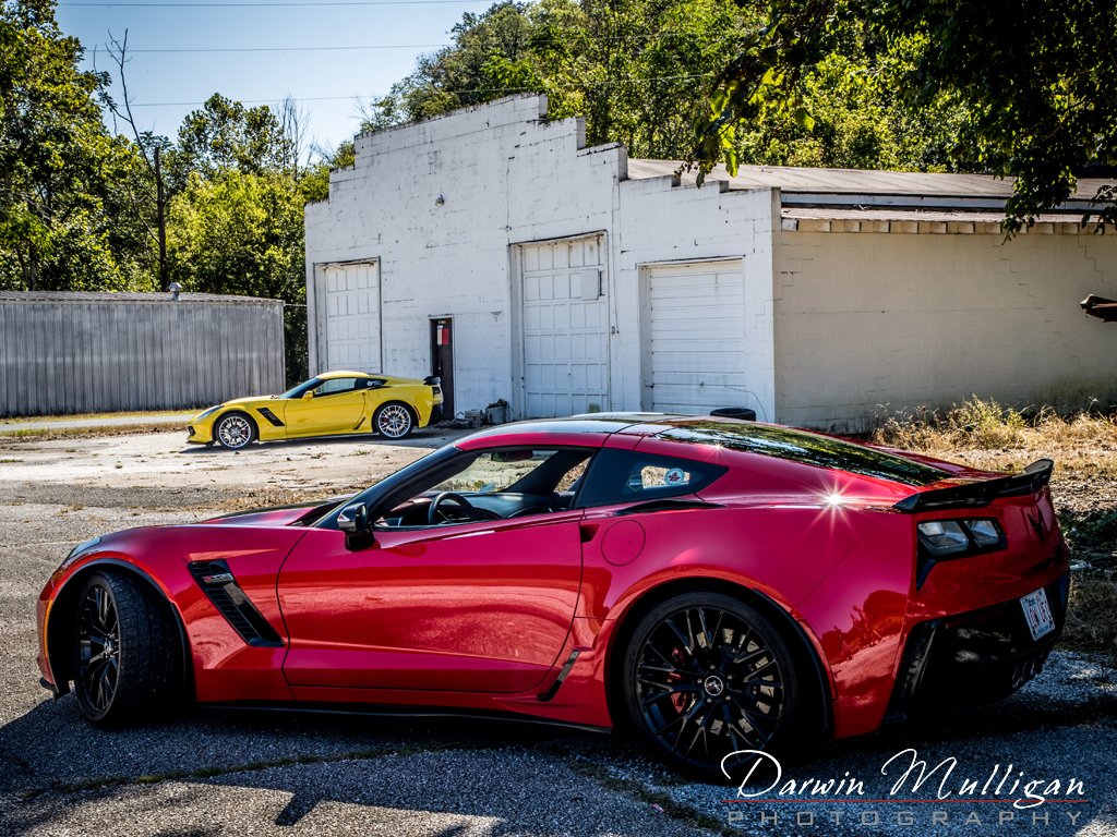 Two Z06 Corvettes and abandoned building