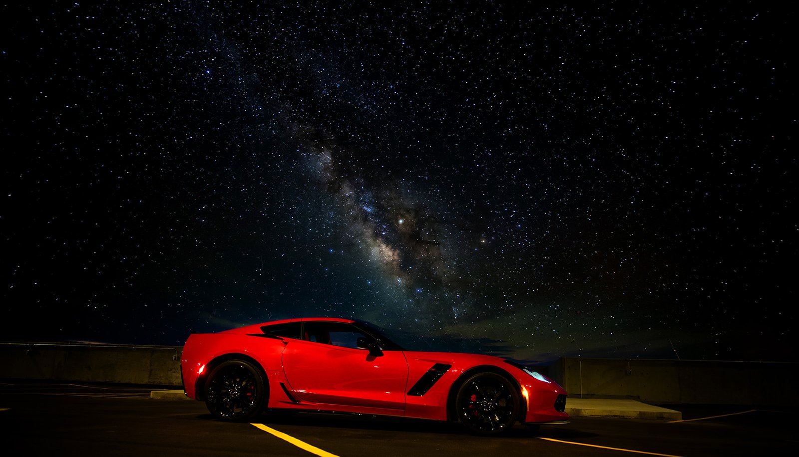 Chevy Corvette Z06 on a parkade rooftop at night with Milky Way visible