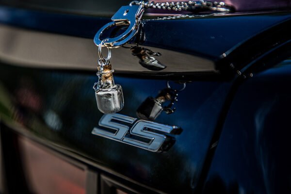 Customer's Dad's ashes in a container attached to car keys in this SS Camaro photo shoot